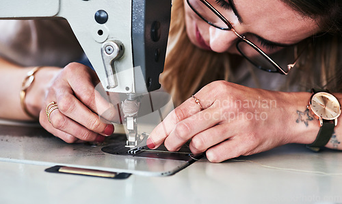 Image of Sewing machine, woman hands and creative fashion designer with button and thread work. Small business, entrepreneur and female tailor with boutique and employee working with machinery for clothing