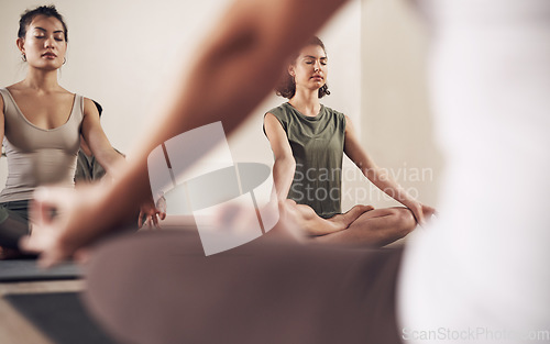 Image of Yoga, meditation teacher and group in a wellness and health class to relax with zen and peace. Female people, spiritual and holistic exercise with calm lotus pose with pilates and woman in gym