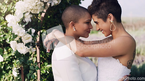 Image of Love, hug and lgbtq with lesbian couple at wedding for celebration, gay and pride. Smile, spring and happiness with women kiss at marriage event for partner commitment, sexuality and freedom