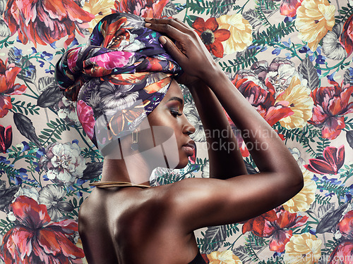 Image of Fashion, beauty and face of black woman on flower background with glamour, cosmetics and makeup. Floral pattern, designer and profile of female person in exotic jewelry, African style and head scarf