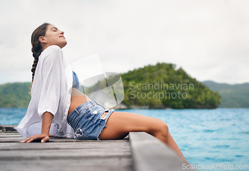 Image of Relax, vacation and woman with boardwalk, happiness and tropical island for break, stress relief and peace. Female person, girl or tourist with seaside holiday, getaway and travel with water and deck