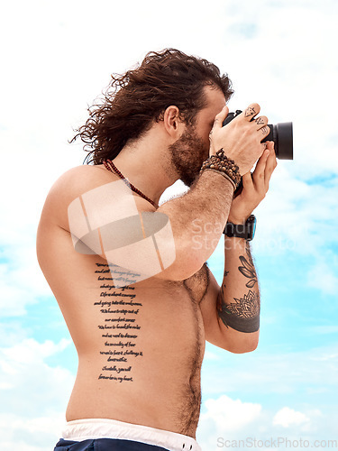 Image of Man, photographer and camera with blue sky and clouds in summer for photo or picture in nature outdoors. Shirtless male person in photography for memory, tourist or holiday weekend pictures outside