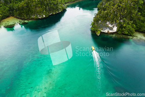 Image of Travel, top view and boat on island river for adventure, holiday and vacation in Mauritius. Nature, sea and aerial drone of yacht in tropical water for transport, sailing and traveling on islands