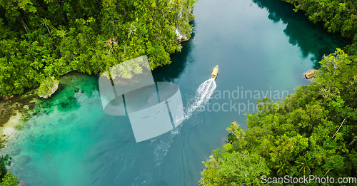 Image of Island, tropical and drone of a boat in nature with trees for sailing on vacation or weekend trip. Travel, adventure and aerial view of speedboat on a river of resort water for summer holiday.