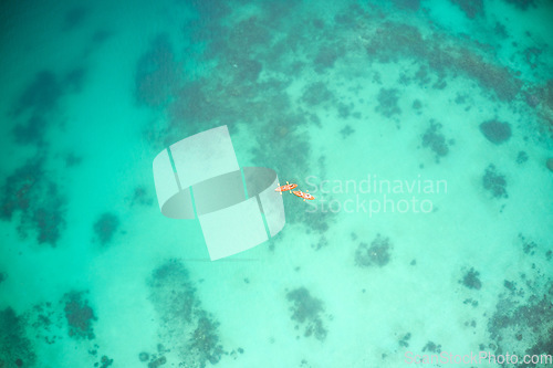 Image of Top view, boat and people at sea for kayak adventure, travel or journey in ocean together outdoors. Couple traveling, kayaking or rowing on calm, peaceful or serene beach water in natural environment