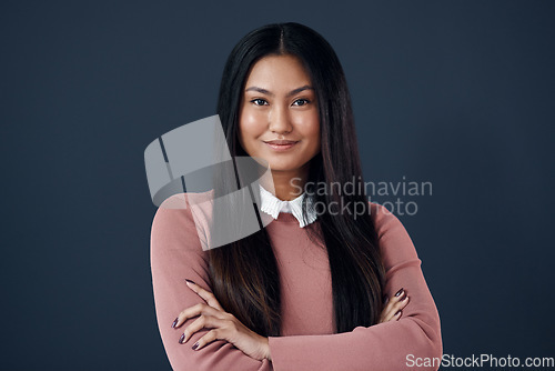 Image of Smile, portrait of Korean woman with arms crossed and on a dark background. Empowerment or confident, professional corporate worker and pose with happy young businesswoman in a studio backdrop.