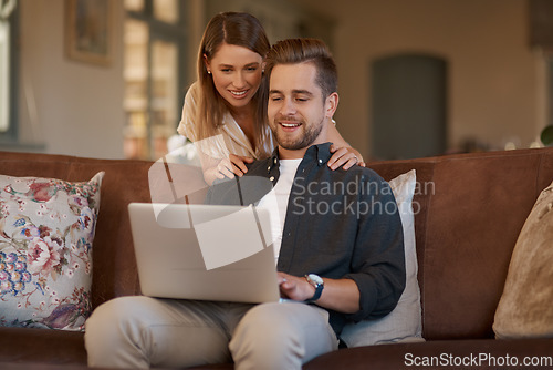 Image of Relax, laptop and web with a couple on the living room sofa of their home together. Computer, social media or internet with a man and woman online to search while relaxing and bonding in a house
