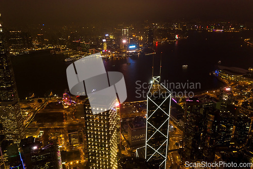 Image of Night, cityscape and urban skyline by buildings, light or architecture for infrastructure, development or expansion. Dark metro, cbd or city background by skyscraper, road or drone view of Hong Kong
