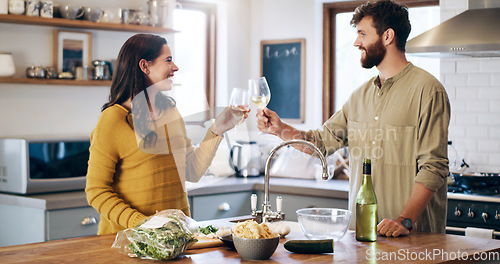 Image of Happy couple, champagne and cheers in kitchen for anniversary, date or celebration together at home. Man and woman in relationship with alcohol or win for valentines day, love or toast at the house