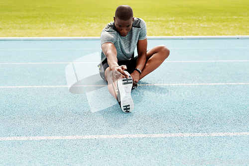 Image of Athlete man, sitting and track for stretching legs to start training, exercise or running for fitness outdoor. African runner, warm up muscle or body for workout at stadium for race, contest or sport