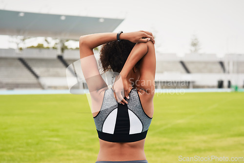 Image of Woman, fitness and back stretching arms on stadium track for running, exercise or workout. Active female person or athlete in warm up body stretch, sports training or athletics on cardio run outdoors