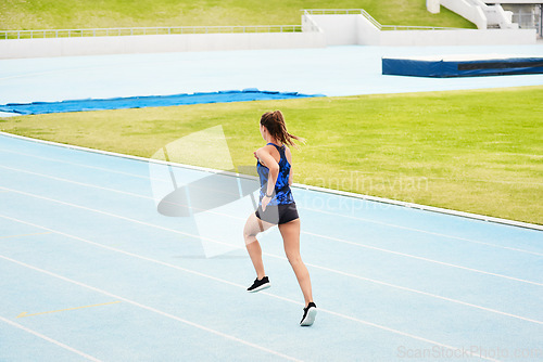 Image of Woman, back and running on stadium track in fitness, exercise or workout for cardio training outdoors. Fit, active or sporty female person, runner or athlete sprinting competition, exercising or race