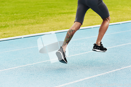 Image of Man, legs and running on track for athletics, fitness or exercise of athlete training at the stadium. Leg of male person or runner exercising in run, workout or sports competition for healthy cardio