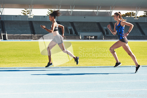 Image of Woman, running and stadium track of athletes in competition, fitness or athletics in the outdoors. Fit, active or sporty women, runner or sprinting in exercise, workout or training for healthy cardio