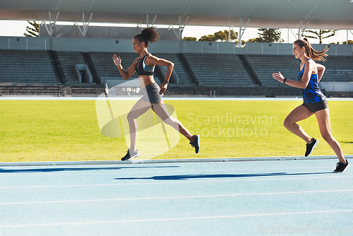 Image of Woman, running and stadium track for race, competition or fitness athletics in the outdoors. Fit, active or sporty women, runner or sprinting in exercise, workout or training for healthy cardio