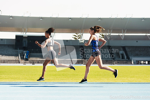 Image of Woman, running and stadium track in competition, race or fitness for athletics in the outdoors. Fit, active or sporty women, runner or sprinting in exercise, workout or training for healthy cardio