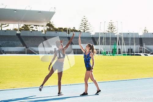 Image of Woman, team and high five on stadium track for running, exercise or training together in athletics outdoors. Women touching hands in celebration for exercising, run or winning in teamwork and fitness