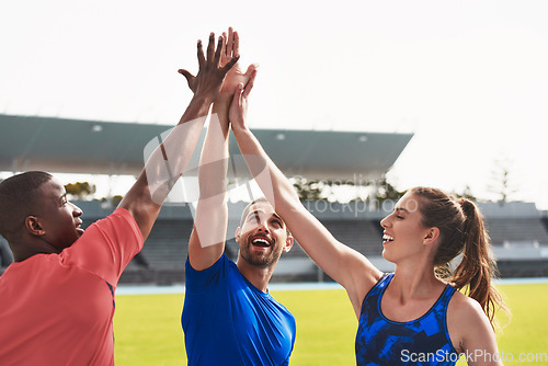 Image of Diversity, team and high five on stadium track for running, exercise or training together in athletics. Group touching hands in celebration or solidarity for exercising, run or winning in fitness