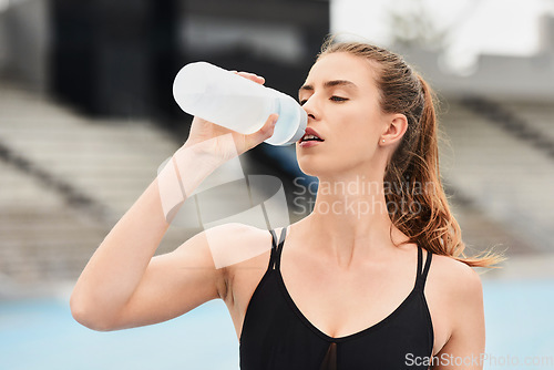 Image of Fitness, woman and runner drinking water for hydration after running exercise, workout or athletic training. Sports, nutrition or thirsty female athlete in rest with drink for natural sustainability