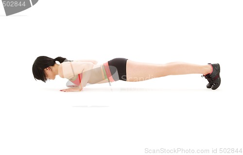Image of woman practicing four-limbed staff pose