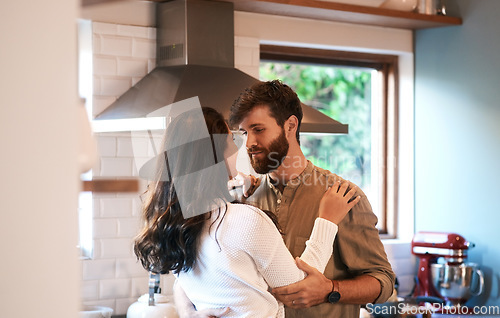 Image of Young couple, dance and kitchen in home with love, passion and cooking together for romance, care or bond. Man, woman and hug with dancing, moving and connection for food, nutrition or diet in house