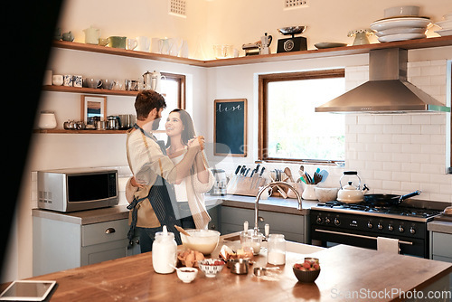 Image of Happy young couple, dancing and kitchen in home with love, comic moment and cooking together with romance. Man, woman and smile with dance, moving and happiness for food, nutrition or diet in house