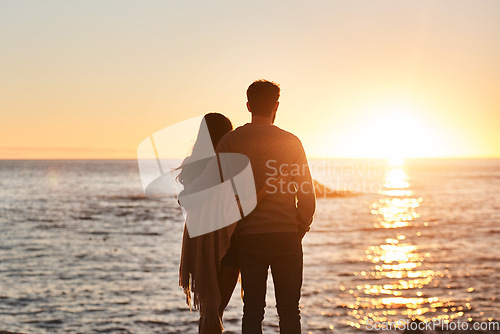 Image of Sunset, beach and back of couple hug in evening on holiday, summer vacation and weekend by ocean. Nature, love and man and woman embrace, hugging and relax for bonding, quality time and peace by sea