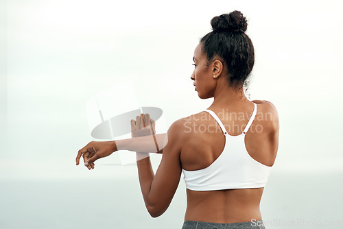 Image of Woman, arm stretching and outdoor for yoga, workout and training with mockup. Wellness, nature and ocean with female person back doing exercise for health with pilates and relax by sea with stretch