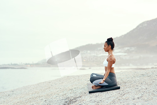Image of Yoga, outdoor meditation and woman on a beach with lotus pose, wellness and fitness. Pilates, sea and young female person on sand with peace in nature feeling relax and calm with spiritual mockup