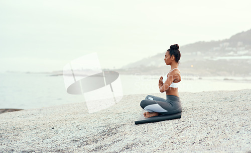 Image of Yoga, medication and woman on a beach with lotus pose, wellness and fitness. Pilates, sea and female person on sand with peace in nature feeling relax and calm with spiritual and holistic mockup