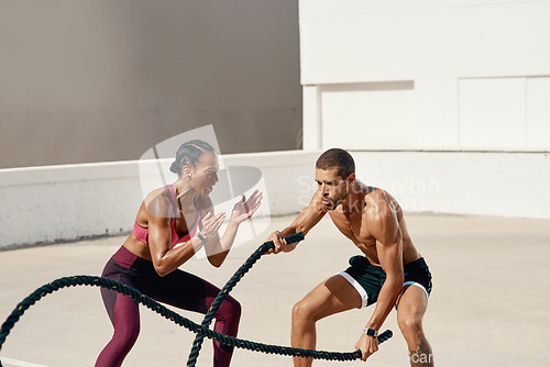 Image of Woman, personal trainer and battle rope training for workout, exercise or fitness outdoors. Fit, active or serious coaching with man person exercising with ropes for sports endurance or motivation