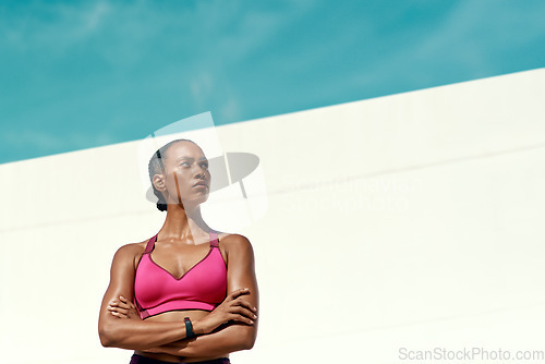 Image of Sports, fitness and serious woman with blue sky, mockup at outdoor gym for health and wellness. Workout, exercise and confidence, fit athlete with focus space and healthy mindset for summer goals.