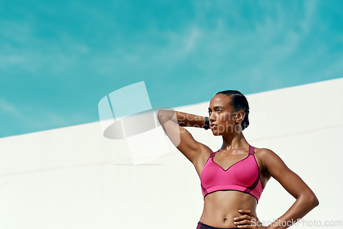 Image of Sports, fitness and woman with blue sky, mockup at outdoor gym and focus on health and wellness. Workout, exercise and confidence, fit athlete with space and healthy mindset for summer body goals.