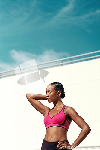 Image of Sports, fitness and sky, woman with mockup, wall at outdoor gym for health and wellness with muscle power. Workout, exercise and athlete with focus, space and healthy mindset for fit summer goals.