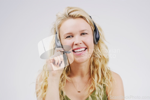 Image of Call center, woman and smile in studio portrait with headset, listening and tech support by white background. Female agent, telemarketing and customer service with mic, voip and happy for consulting