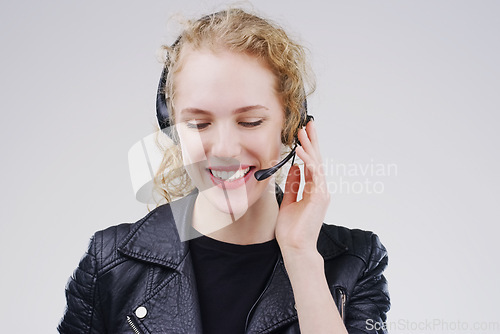 Image of Call center, woman and listening in studio with headset, smile or thinking for tech support by white background. Crm girl, telemarketing and help desk with microphone, voip and happy for consulting