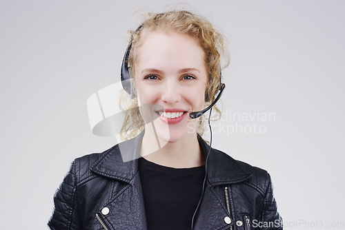 Image of Call center, woman and studio portrait with headset, smile and microphone for tech support by background. Crm agent, telemarketing and customer service with mic, voip and happy for consulting job