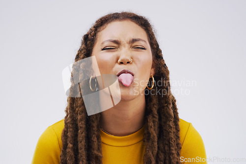 Image of Portrait, funny face and tongue with a black woman joking in studio on a white background for humor. Comic, comedy and braids on eyes with a playful young female person eyes closed for an emoji