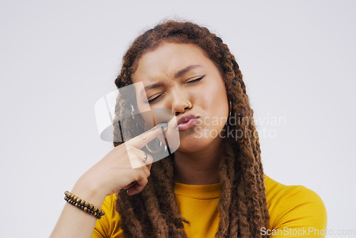 Image of Finger, funny face and pout with a black woman joking in studio on a white background for humor. Comic, comedy and duckface with a pouting young female person feeling playful while having fun