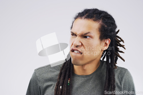 Image of Man, funny face and goofy expression on mockup space against a white studio background. Young male person or model with silly faces and braids for comedy, comic or crazy mood and strange attitude