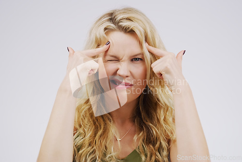 Image of Portrait, funny face and fingers on head with a woman in studio on a gray background looking silly or goofy. Comedy, comic and mental with a crazy young female person joking for fun or playful humor