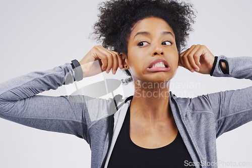 Image of Funny face, pulling ears and an african woman in studio on a gray background, thinking while looking silly or goofy. Comedy, comic and idea with a crazy young female person joking for fun or humor