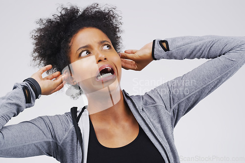 Image of Surprise, funny face and ears with an african woman in studio on a gray background looking silly or goofy. Comedy, comic and shock with a crazy young female person in awe of hearing news while joking