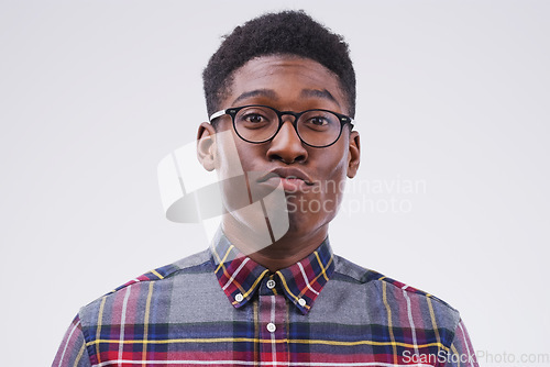 Image of Funny face, young and portrait of a black man pouting isolated on a white background in a studio. Geek, pout and a face headshot of an African person with glasses as a nerd, goofy and quirky