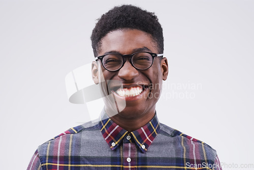 Image of Portrait, mockup and black man with a smile, funny and confident against a grey studio background. Face, male person and model with facial expression, humor and geek laughing, comic and happiness