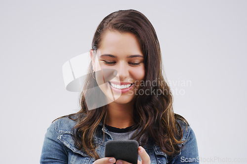 Image of Smile, contact and woman with a phone, typing and social media on a white studio background. Female person, girl and model with a smartphone, connection and online reading with sms and website info
