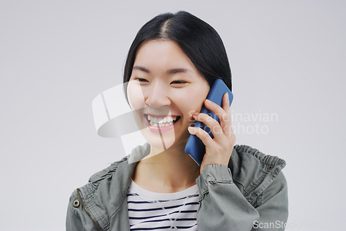 Image of Happy, phone call and Asian woman talking in studio isolated on a white background. Funny, cellphone and female person speaking, discussion or communication, conversation and networking with contact.