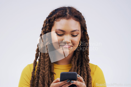 Image of Phone, typing and face of woman in studio with smile for social media, internet and online chat. Communication, white background and female person on smartphone for website, mobile app and texting