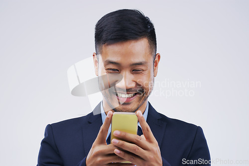 Image of Smile, phone and Asian business man in studio isolated on white background. Happy, cellphone and male person typing for email, web scroll or browsing online, social media or internet app for texting.