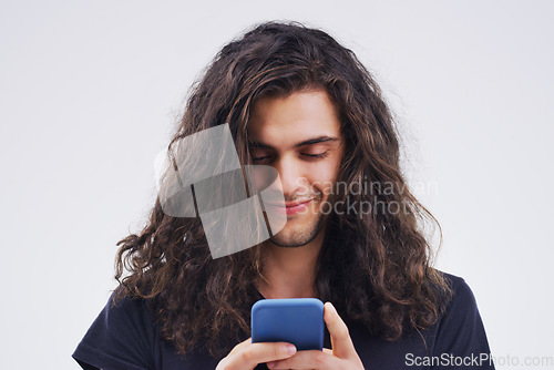 Image of Phone, typing and face of man in studio for social media post, internet and online chat. Communication, white background and happy male person on smartphone for website, mobile app and networking